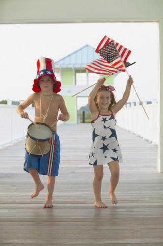 Boy and girl marching on Fourth of July
