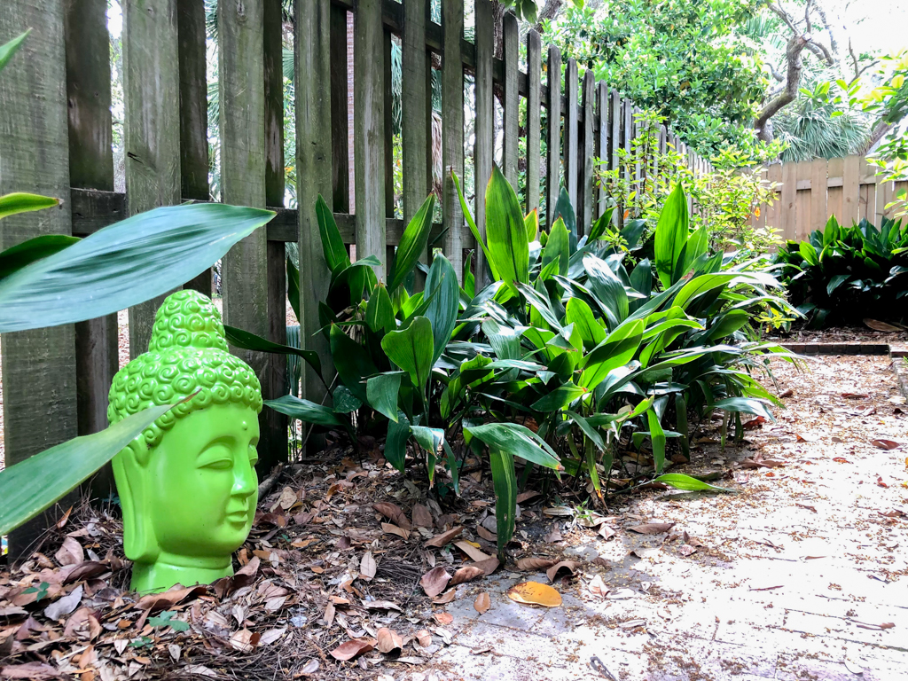blue skies yard buddha